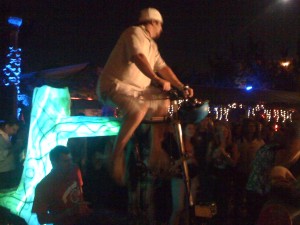 Two dudes riding the same bike while powering their built in lights and PA.